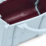 Close up of blue bags, showing texture of the cow leather fabric