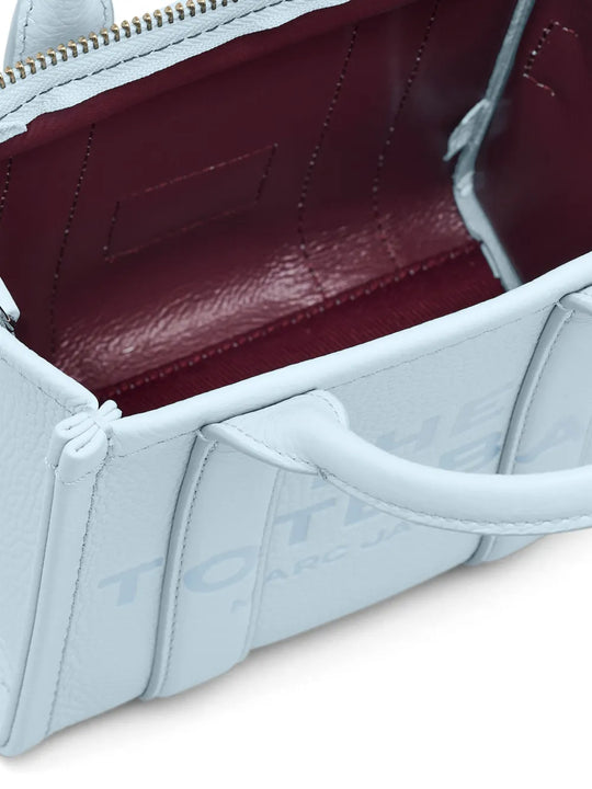 Close up of blue bags, showing texture of the cow leather fabric