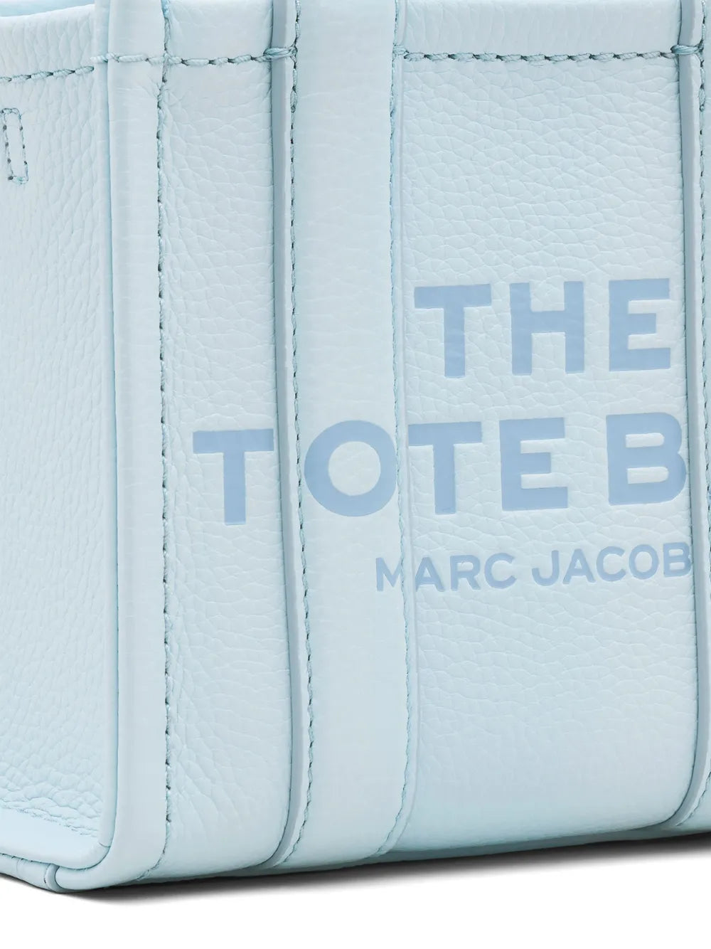 Close up of blue bags, showing texture of the cow leather fabric