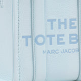 Close up of blue bags, showing texture of the cow leather fabric