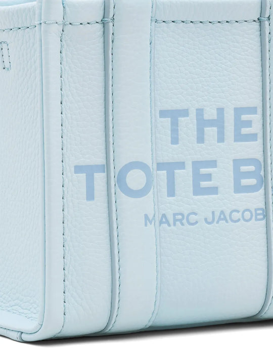 Close up of blue bags, showing texture of the cow leather fabric