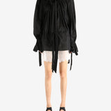 Black dress worn by a person, showing the dress's fit