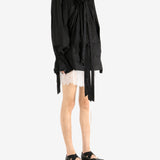 Black dress worn by a person, showing the dress's fit