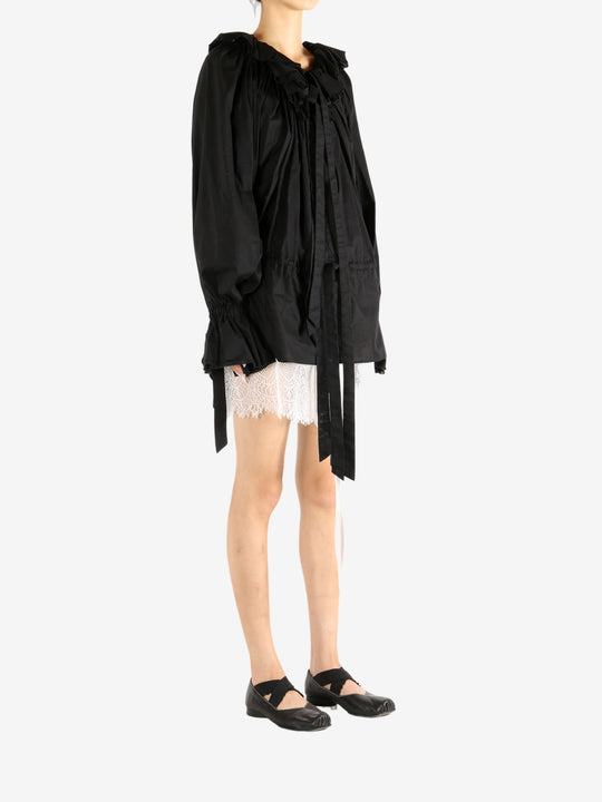 Black dress worn by a person, showing the dress's fit