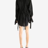 Black dress worn by a person, showing the dress's fit