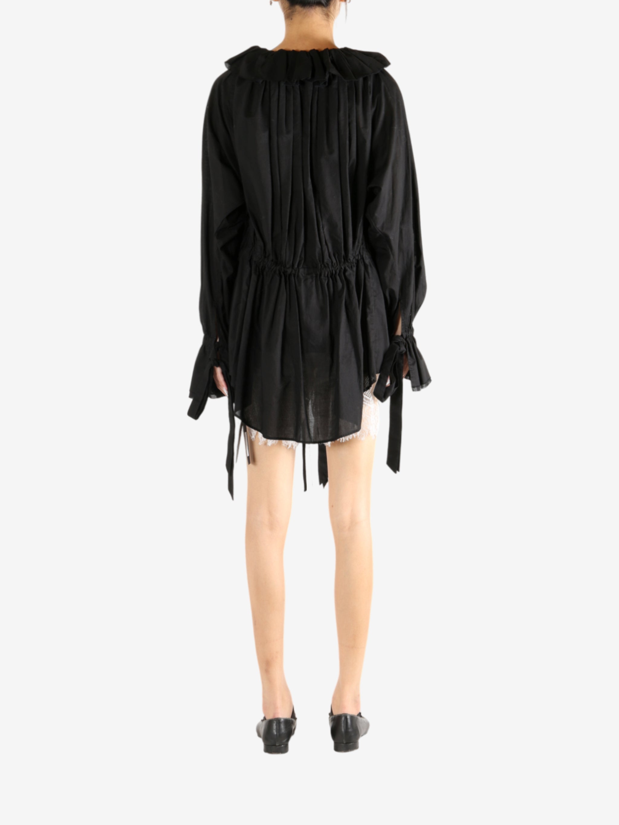 Black dress worn by a person, showing the dress's fit