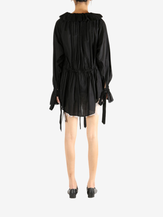 Black dress worn by a person, showing the dress's fit