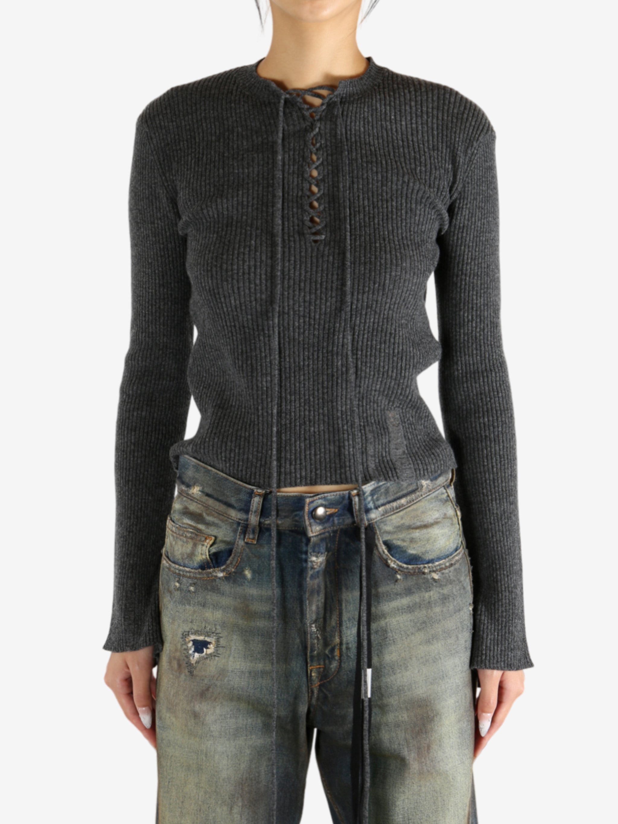 Grey sweater worn by a person,showing the knitwear's fit