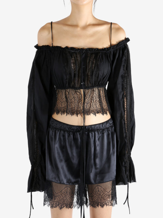 Black top worn by a person, showing the top's fit