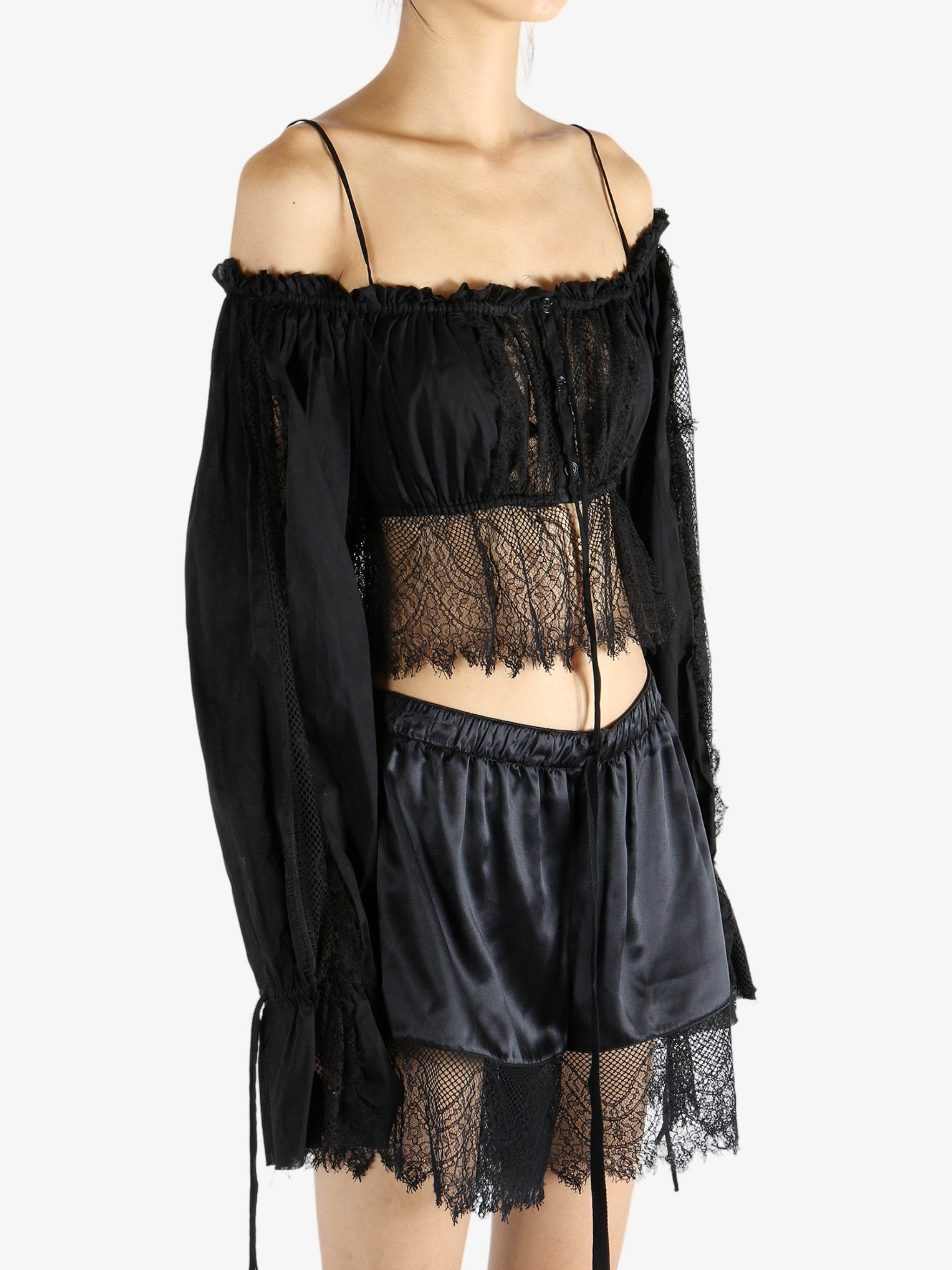 Black top worn by a person, showing the top's fit