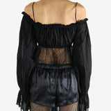 Black top worn by a person, showing the top's fit