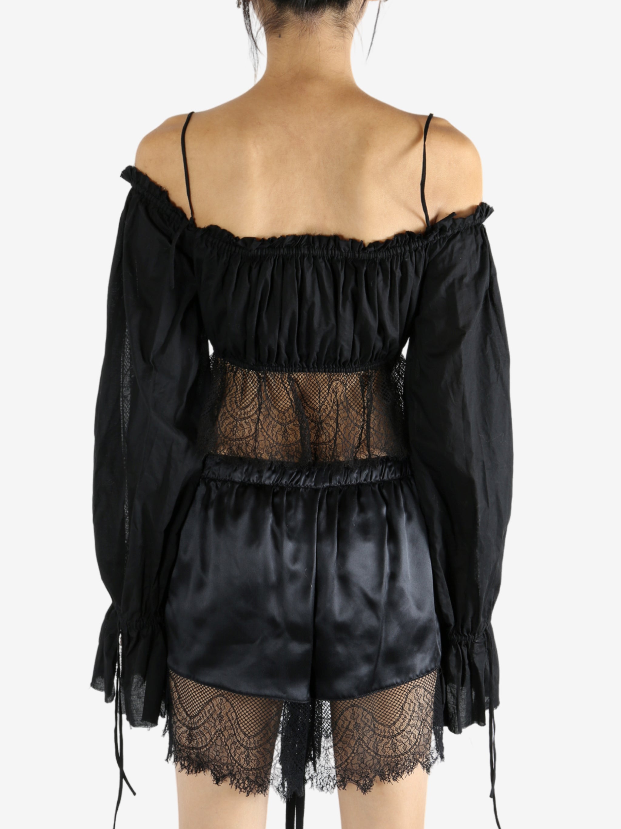 Black top worn by a person, showing the top's fit