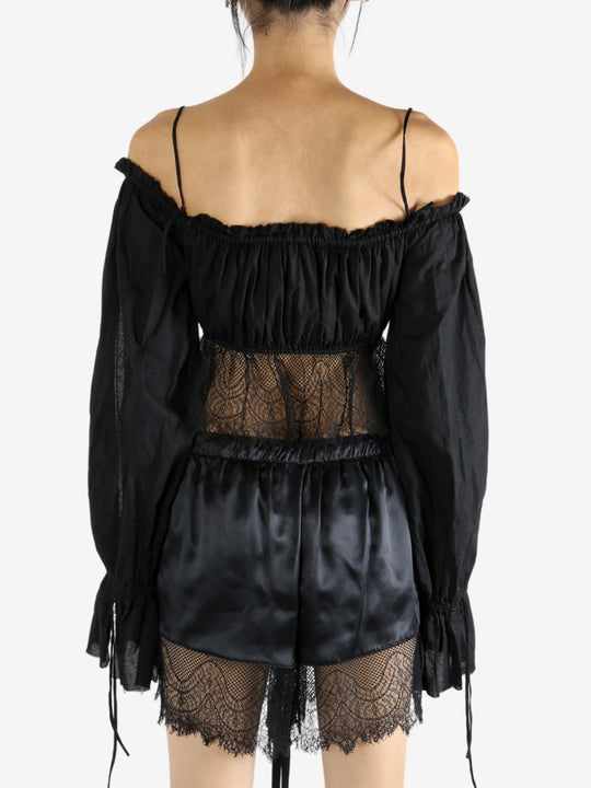 Black top worn by a person, showing the top's fit