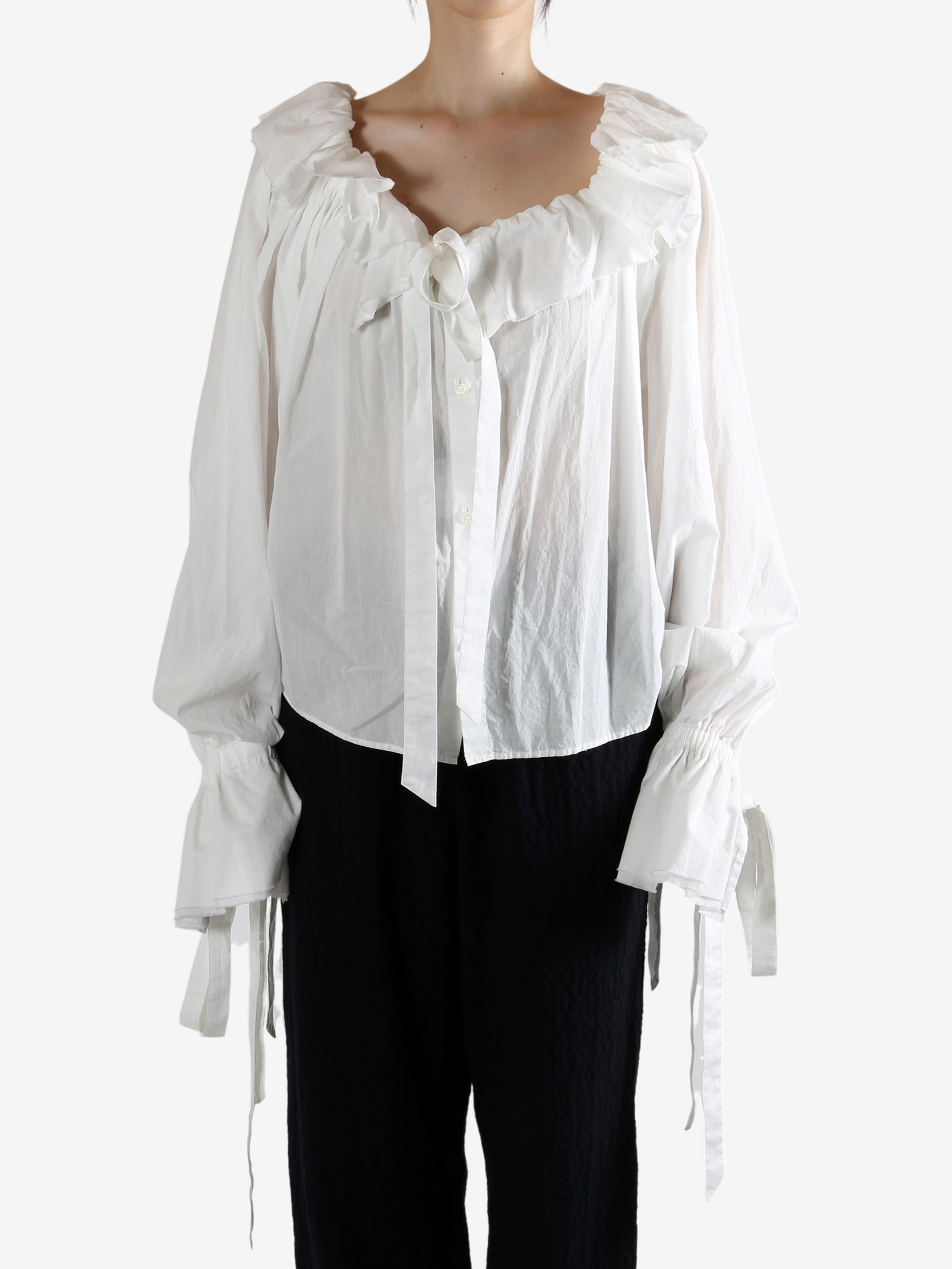 White top worn by a person, showing the top's fit