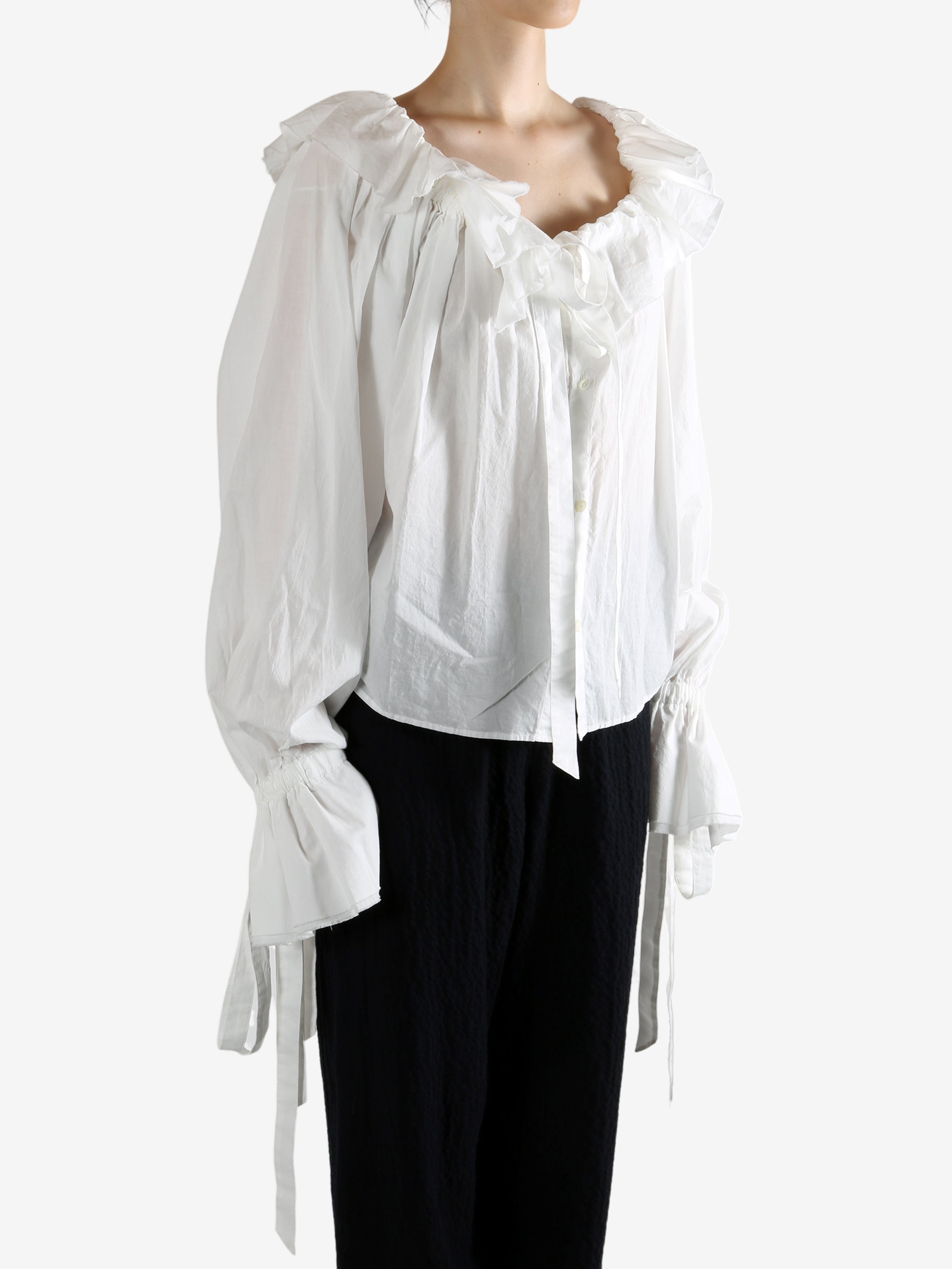 White top worn by a person, showing the top's fit