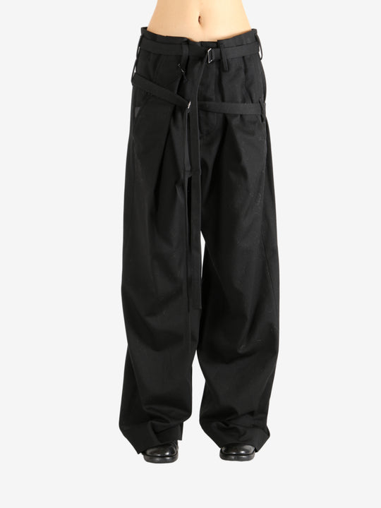 Black pants worn by a person, showing the pants' fit