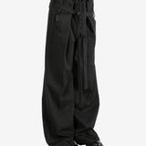 Black pants worn by a person, showing the pants' fit