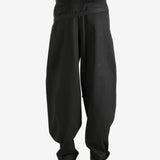 Black pants worn by a person, showing the pants' fit