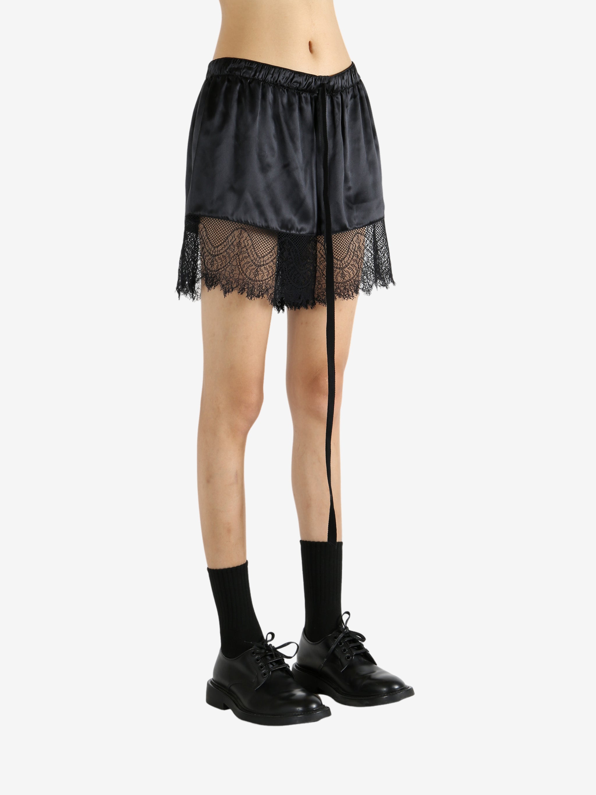 Black shorts worn by a person, showing the shorts' fit