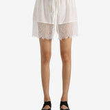 White shorts worn by a person, showing the shorts' fit