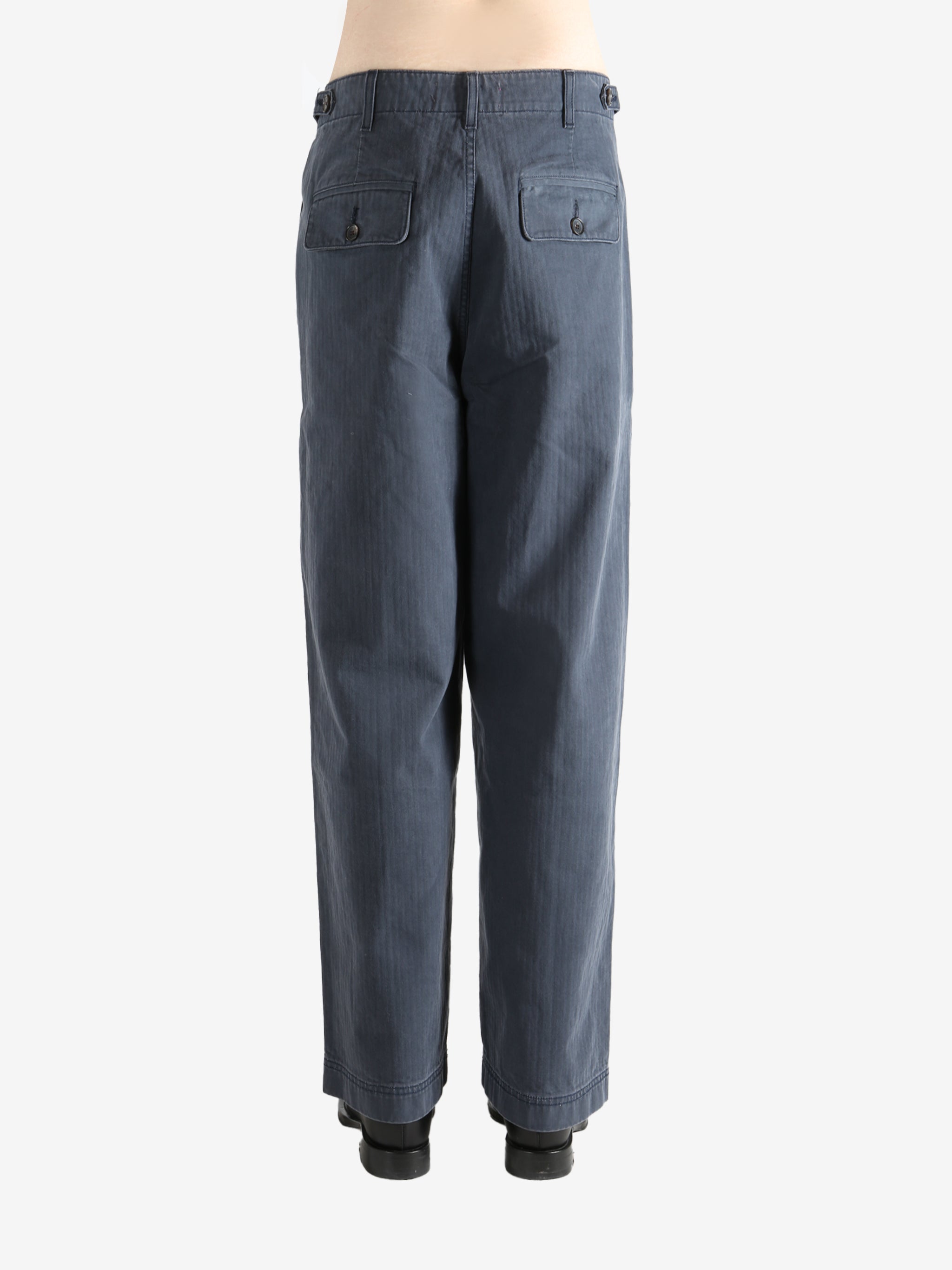 Grey pants worn by a person, showing the pants' fit