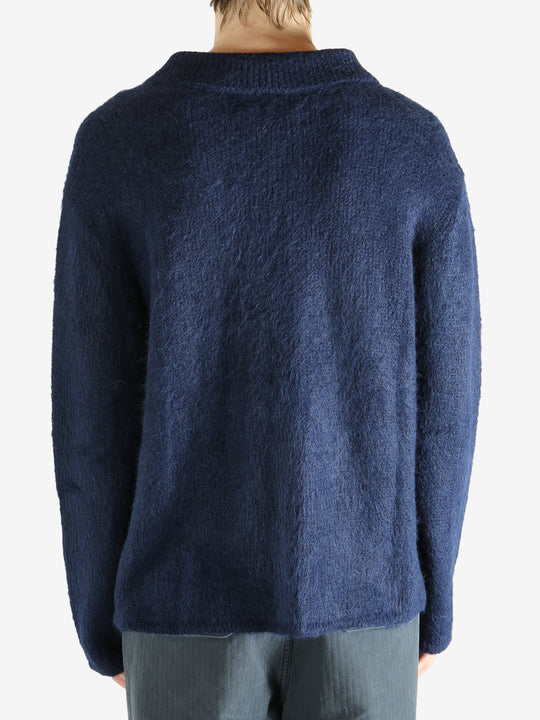 Navy cardigan worn by a person, showing the cardigan's fit