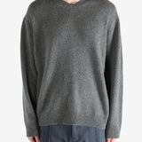 Gray sweater worn by a person, showing the sweater's fit