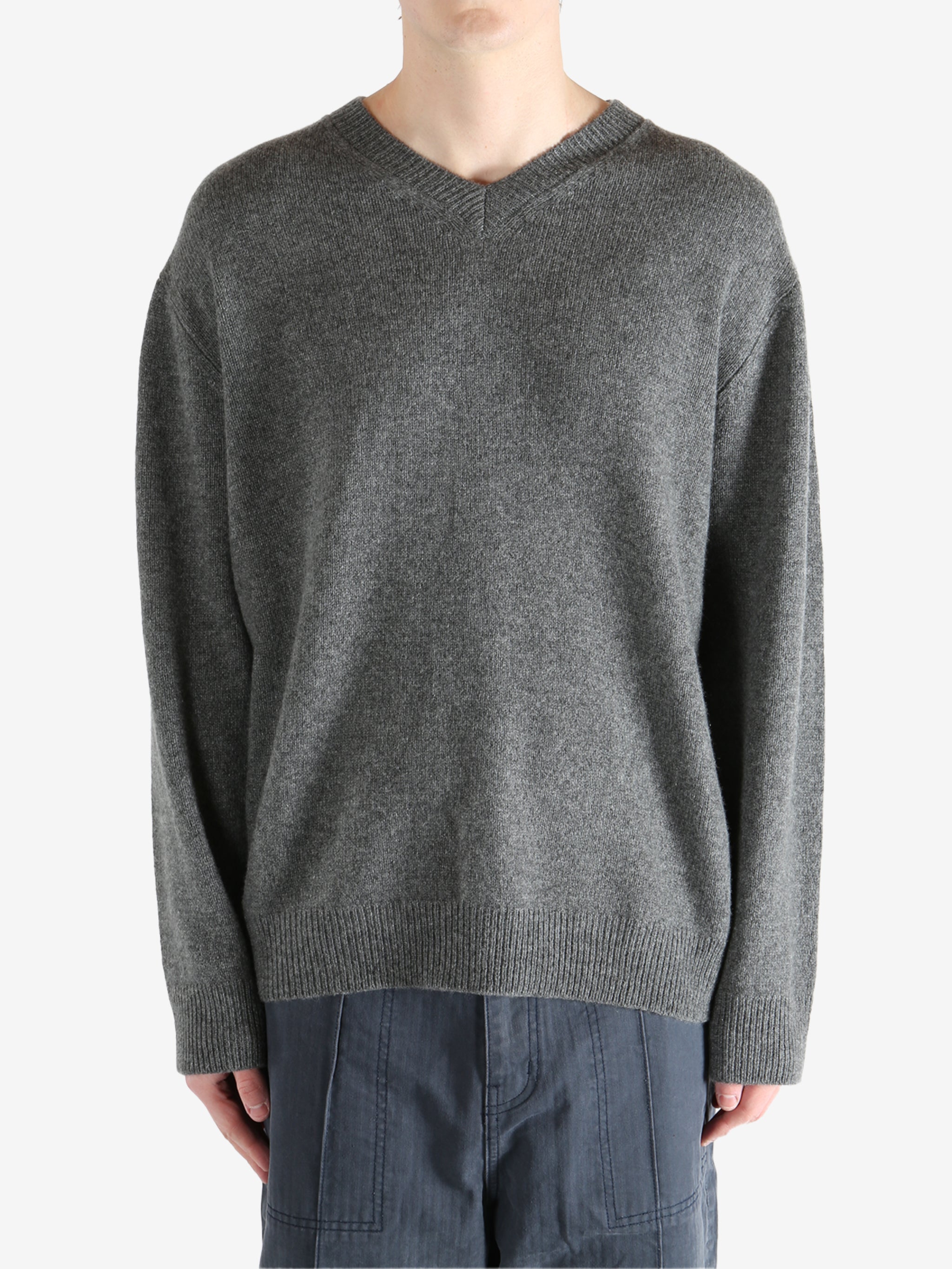 Gray sweater worn by a person, showing the sweater's fit