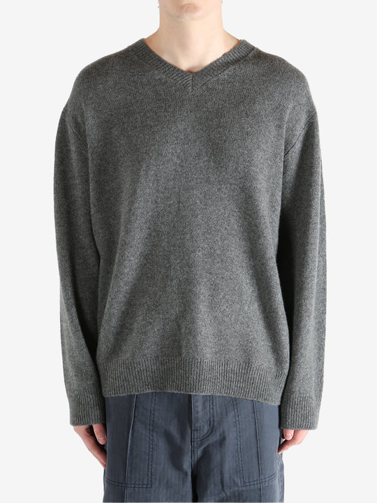 Gray sweater worn by a person, showing the sweater's fit