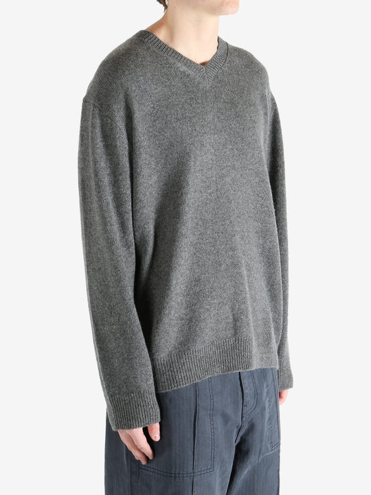 Gray sweater worn by a person, showing the sweater's fit
