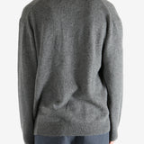 Gray sweater worn by a person, showing the sweater's fit