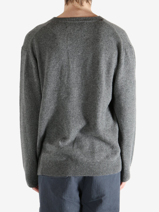 Gray sweater worn by a person, showing the sweater's fit