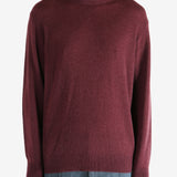 Red sweater worn by a person, showing the sweater fit