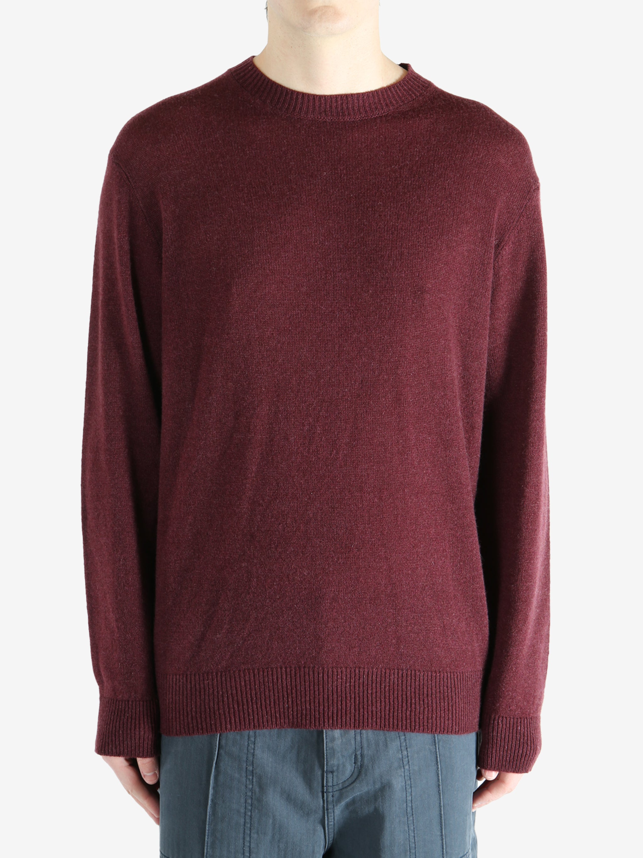 Red sweater worn by a person, showing the sweater fit