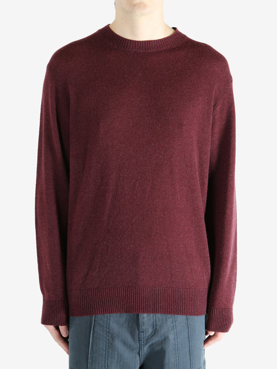 Red sweater worn by a person, showing the sweater fit