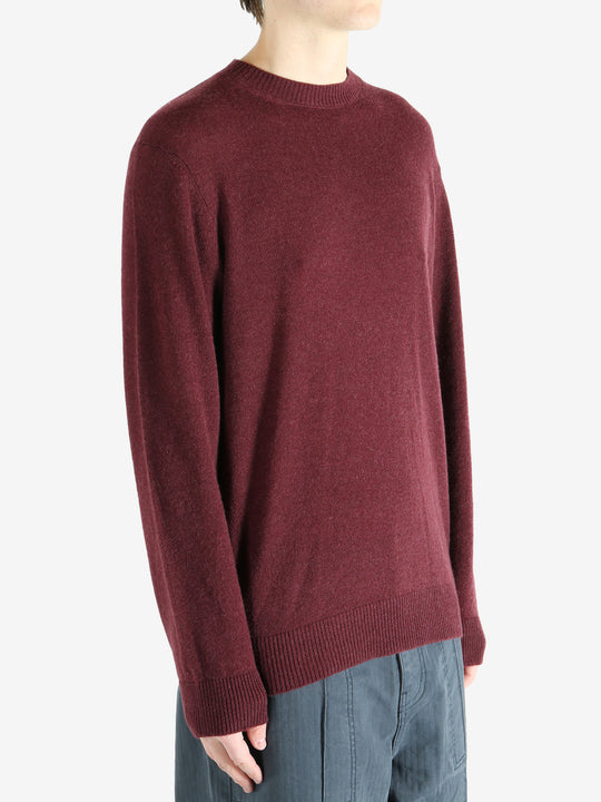 Red sweater worn by a person, showing the sweater fit