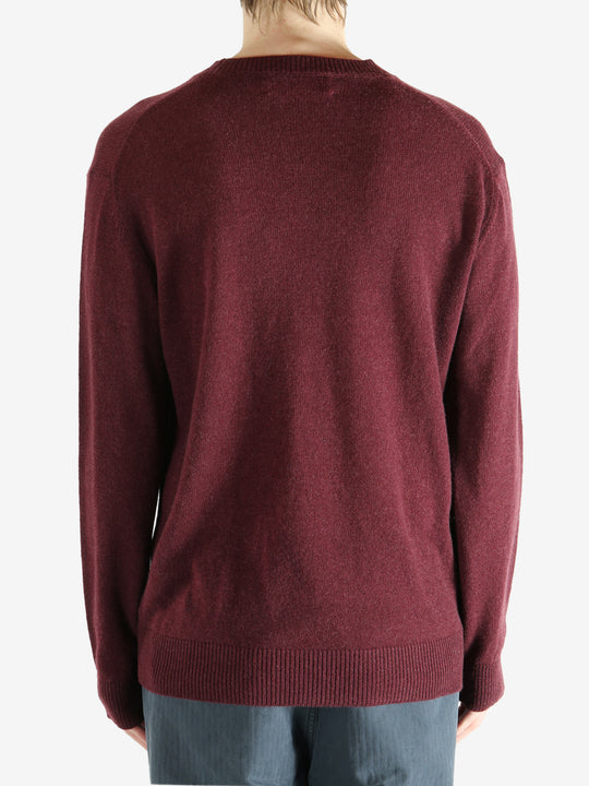 Red sweater worn by a person, showing the sweater fit