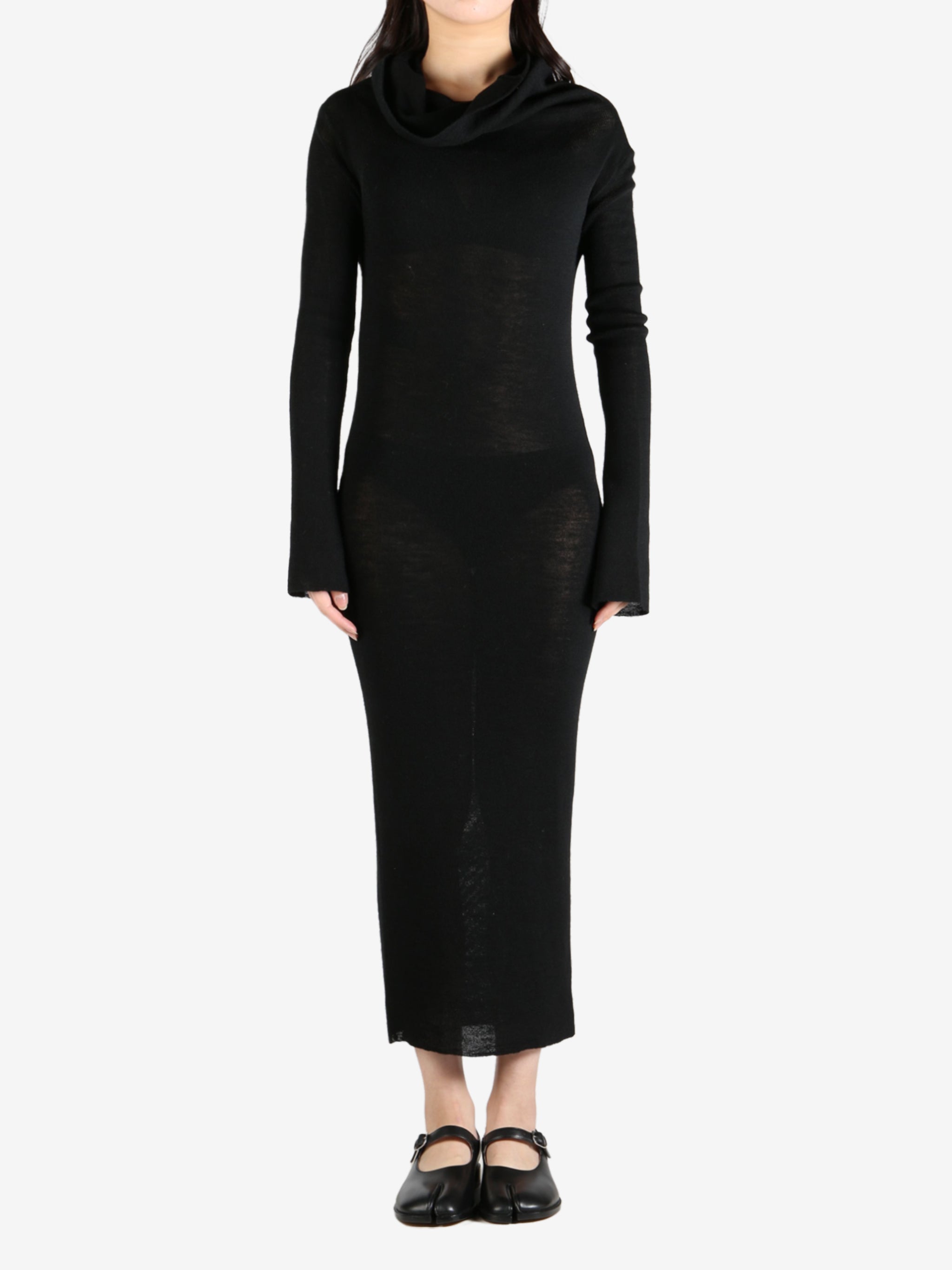 Black dress worn by a person, showing the dress's fit