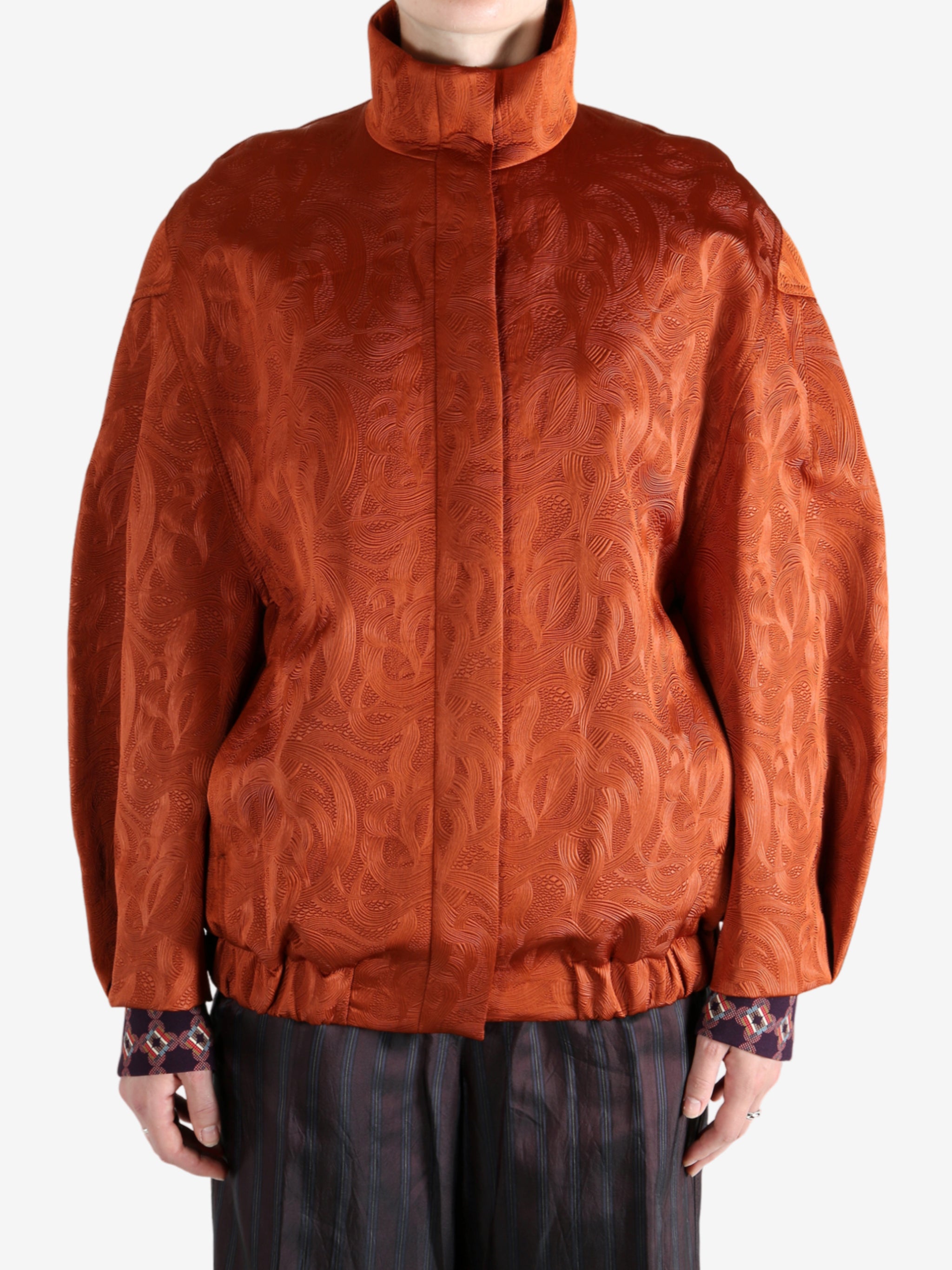 Orange jacket worn by a person, showing the jacket fit