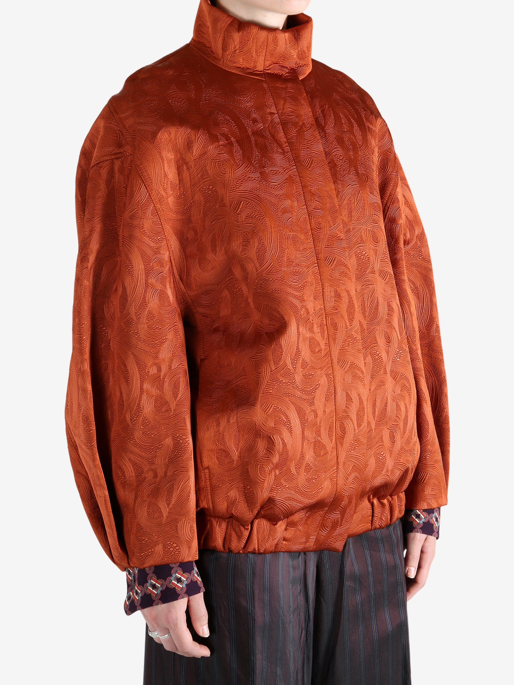 Orange jacket worn by a person, showing the jacket fit