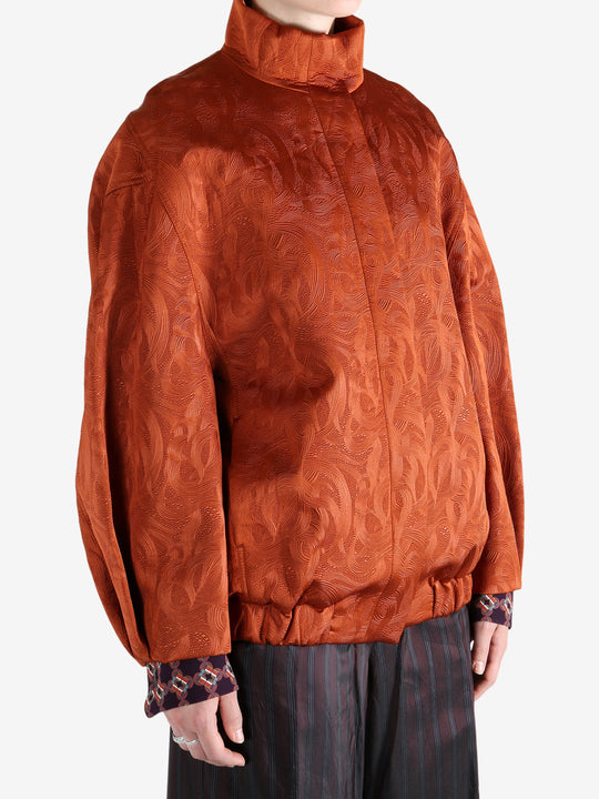 Orange jacket worn by a person, showing the jacket fit