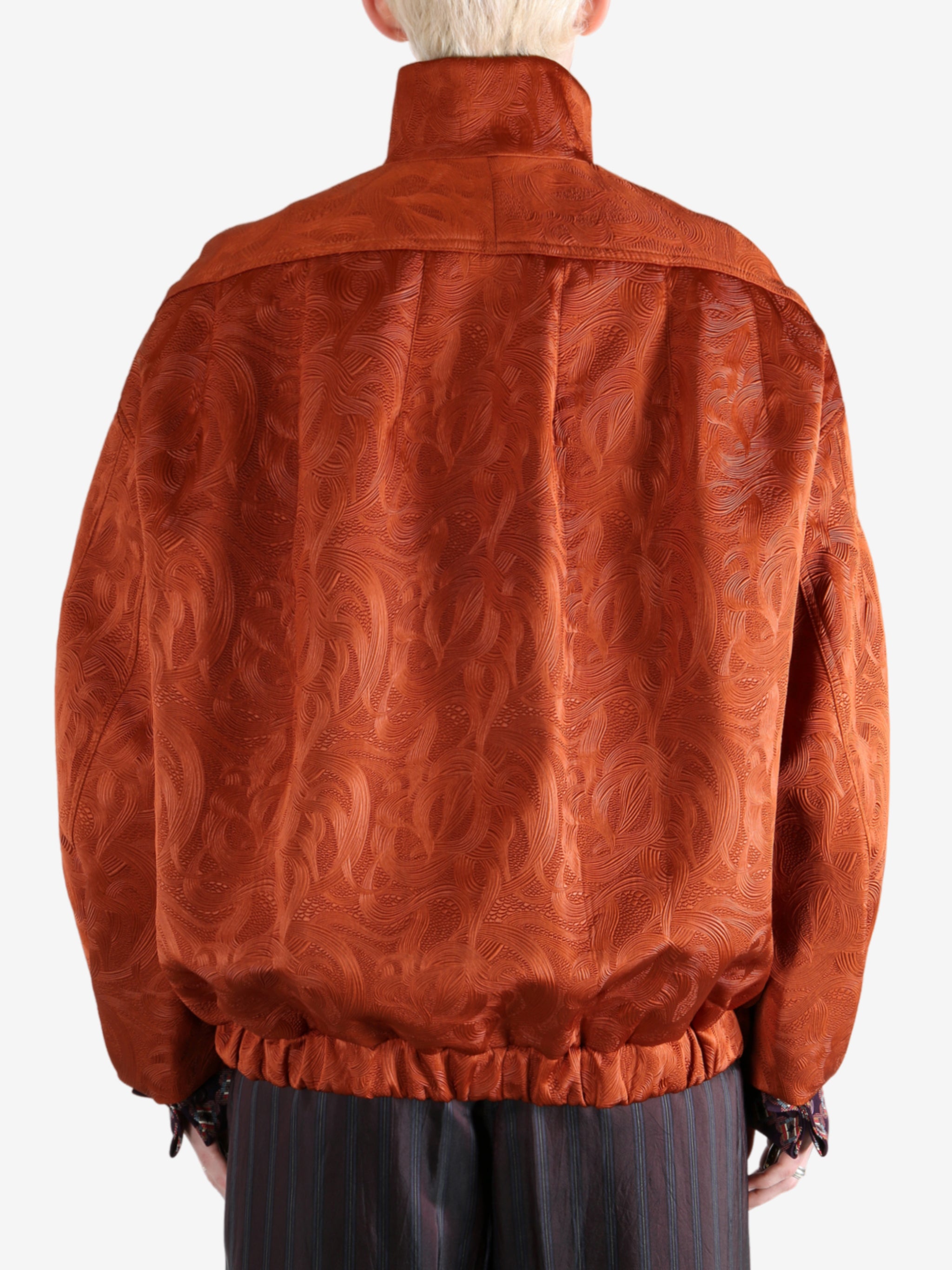 Orange jacket worn by a person, showing the jacket fit