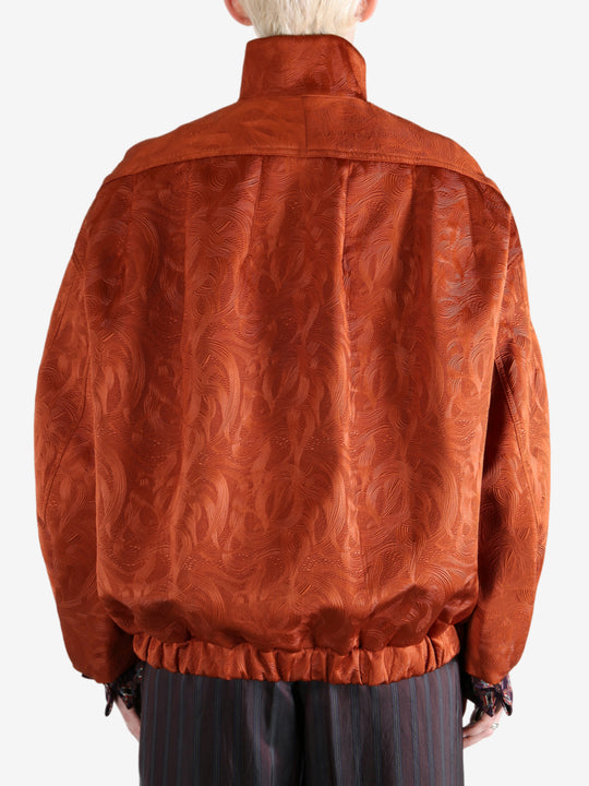 Orange jacket worn by a person, showing the jacket fit