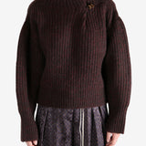 Red sweater worn by a person, showing the sweater's fit