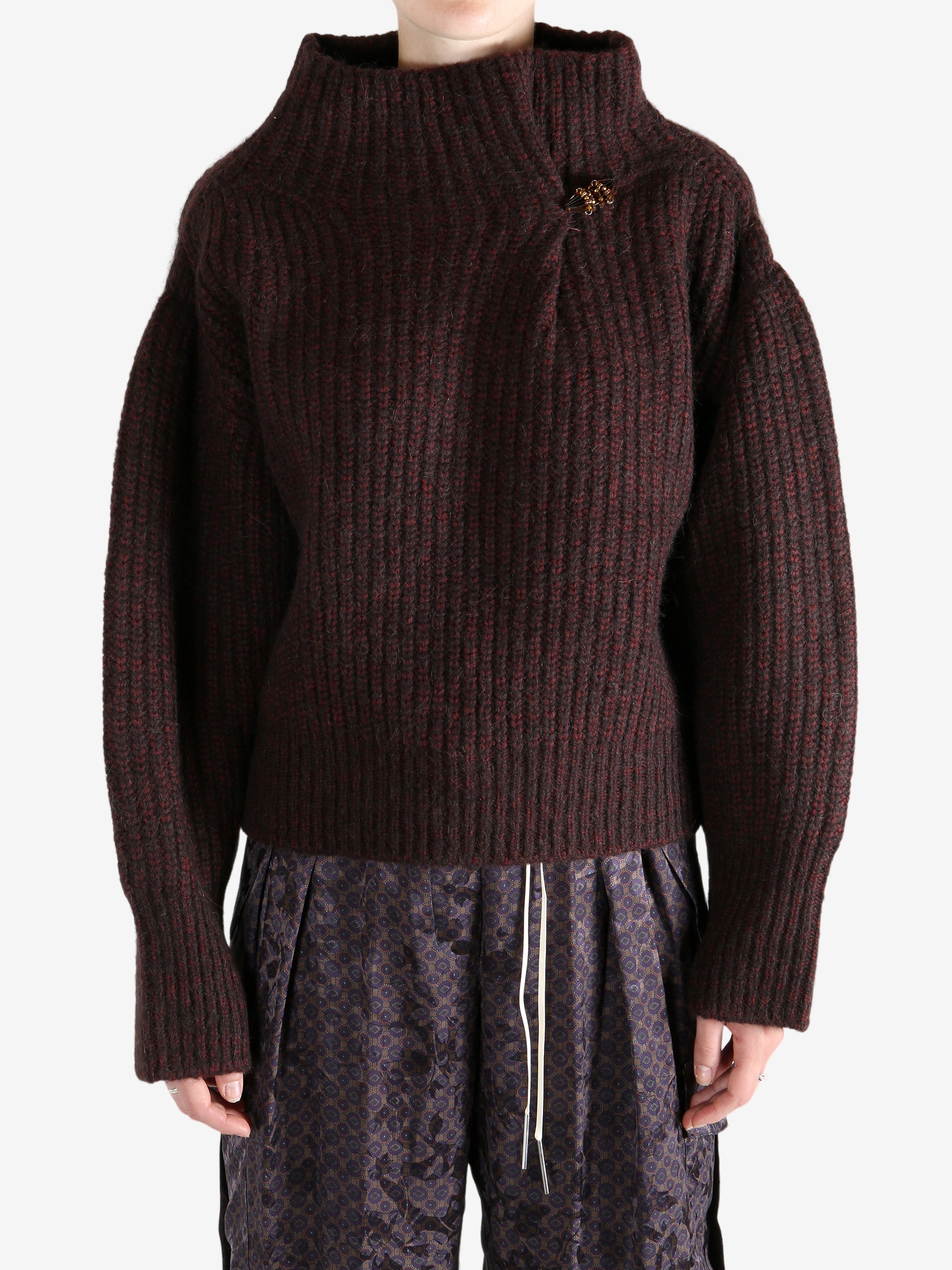 Red sweater worn by a person, showing the sweater's fit