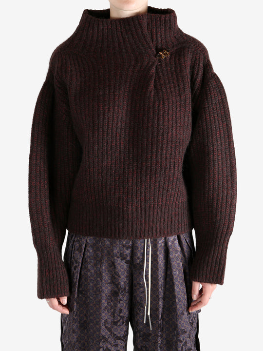 Red sweater worn by a person, showing the sweater's fit