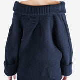 Black sweater worn by a person, showing the sweater's fit