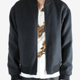 Gray jacket worn by a person, showing the jacket's fit