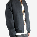 Gray jacket worn by a person, showing the jacket's fit