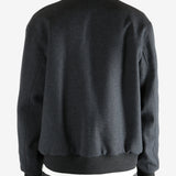 Gray jacket worn by a person, showing the jacket's fit